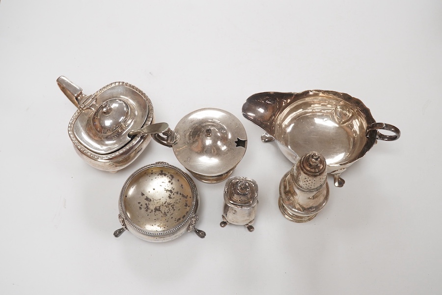 A George II provincial silver sauceboat, John Langlands I, Newcastle, 1751, a.f. and five assorted silver condiments including a George II silver pepperette, London, 1750, 11.2cm. Condition - poor to fair